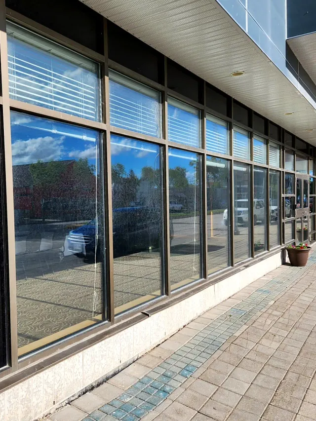 Storefront windows before cleaning, with spots and streaks on the glass