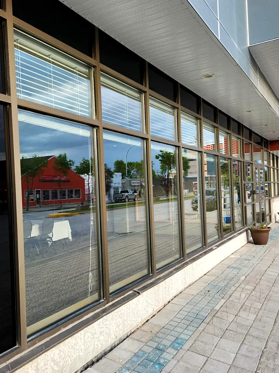 Storefront windows after cleaning, clear glass along a paved walkway